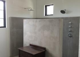 Concrete showers and floors. Rain head, handheld plumbing fixtures.